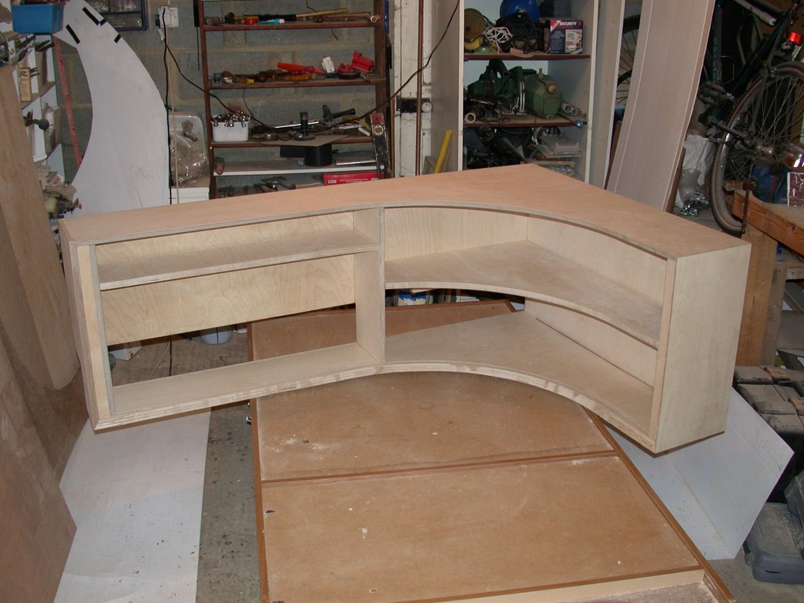 The curved birch ply unit being built in a garage