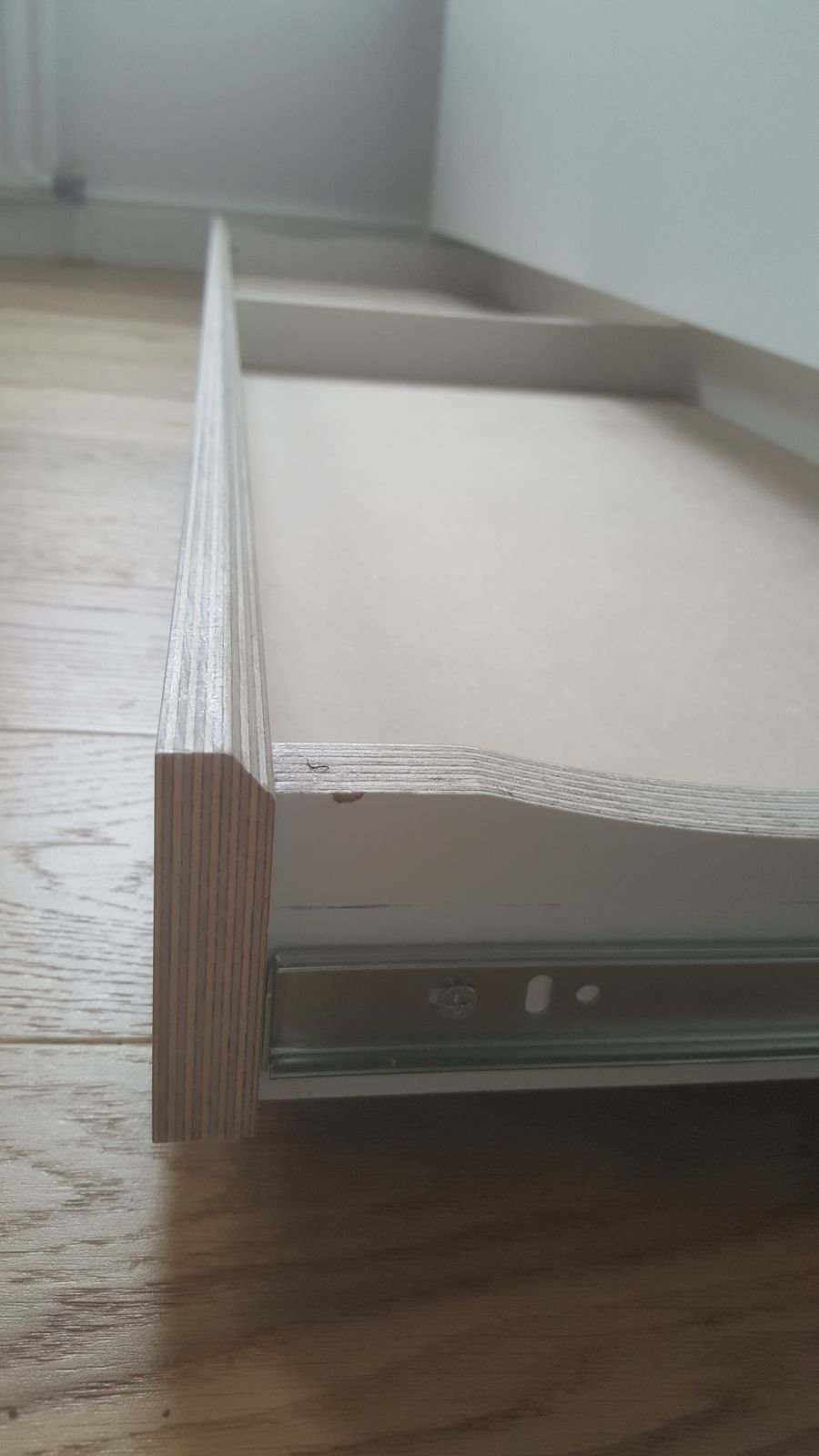 The drawer under the bed on metal runners