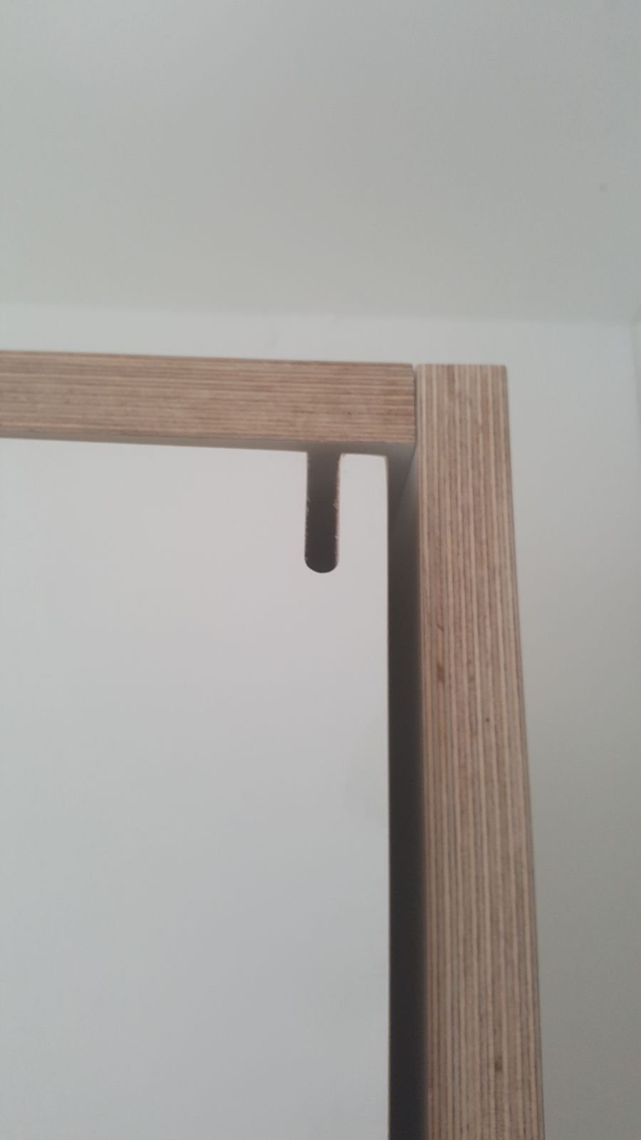 Close-up of a birch plywood edge on the folding bed frame