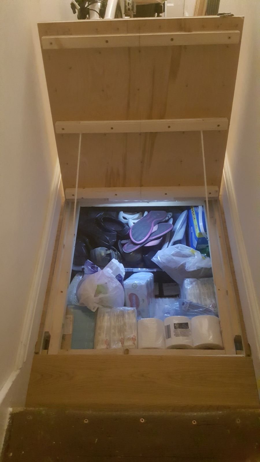 The flap lifted, with bulk storage underneath