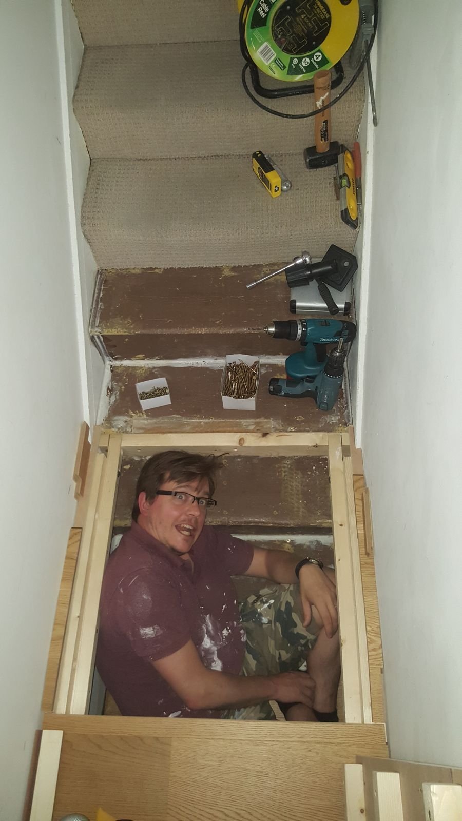 Simon inside the storage space under the raised floor