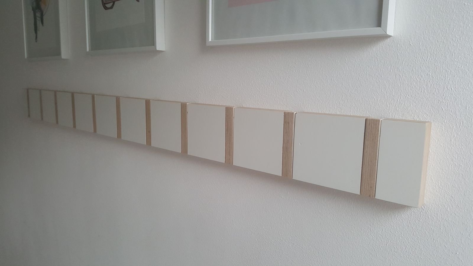 The same row with every hook folded flat to the wall