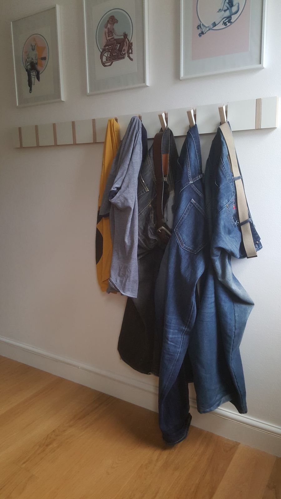 The hook board with several pieces of clothing hung