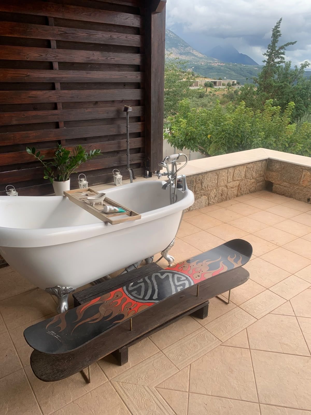 The table beside an outdoor roll-top bath on a terrace